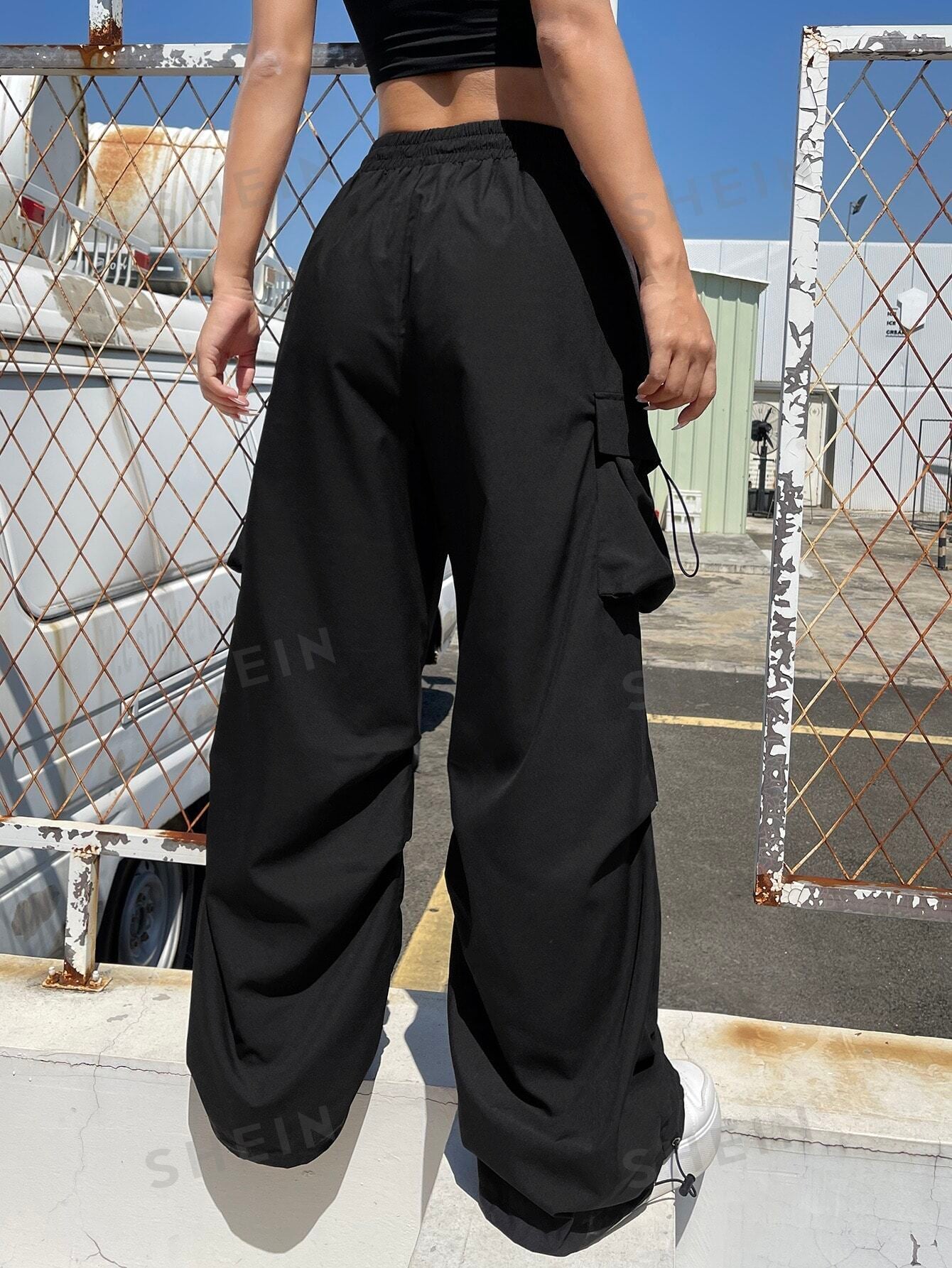 سروال باراشوت الرياضي سوداء اللون بجيوب يلتف بالكتف للنساء، ملابس رياضية للشارع و الرياضة مع أربطة جانبية عند الخصر