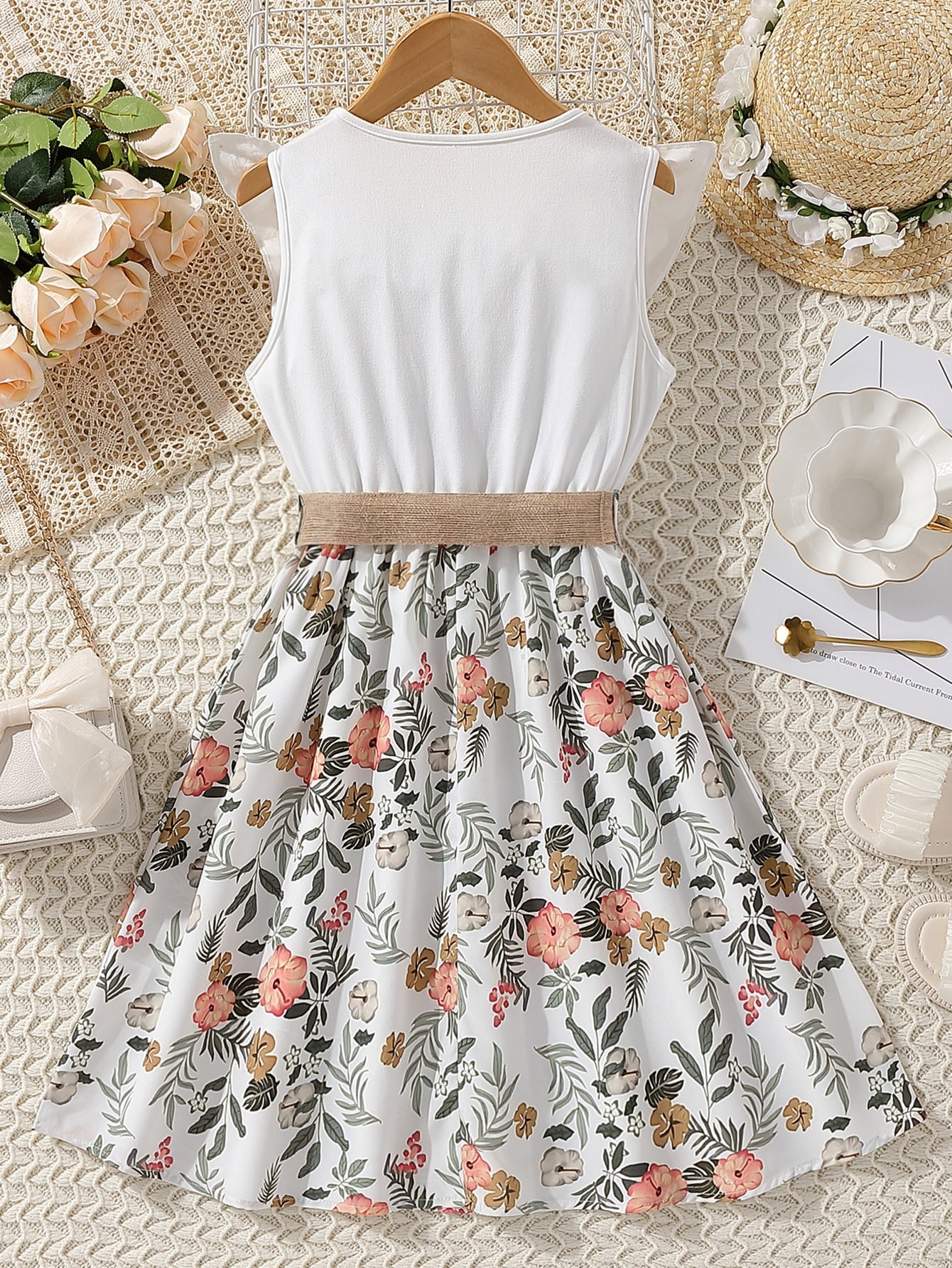 فتاة مراهقة فاتنة بفستان بلا أكمام مطبوع بطبعات الزهور وبحافة مجعدة، يأتي مع حزام الخصر