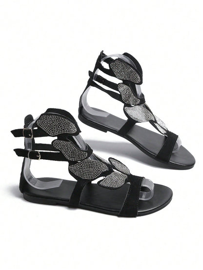 صنادل نسائي مصارع بحزام الكاحل مزخرف بأحجار الراين ، صنادل مسطح من جلد الغزال الصناعي الأسود الفاتح