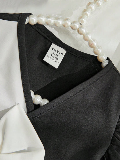 تي شيرت مع زينة القوس وأكمام منتفخة بلونين مع بنطلون بأرجل واسعة وقبعة لطفلة