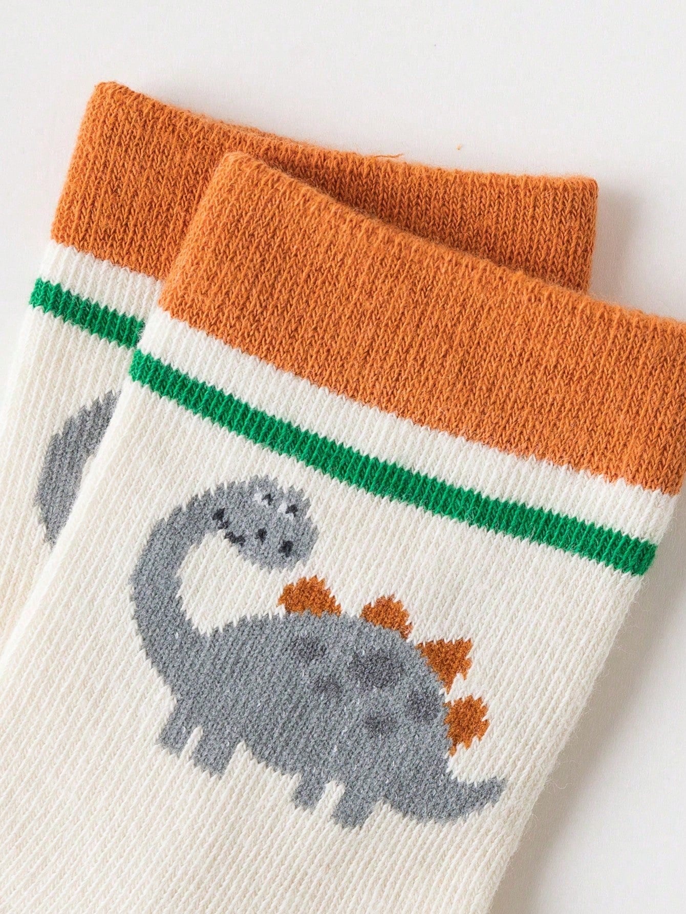 زوج واحد من الجوارب المخططة على شكل ديناصور وأسد